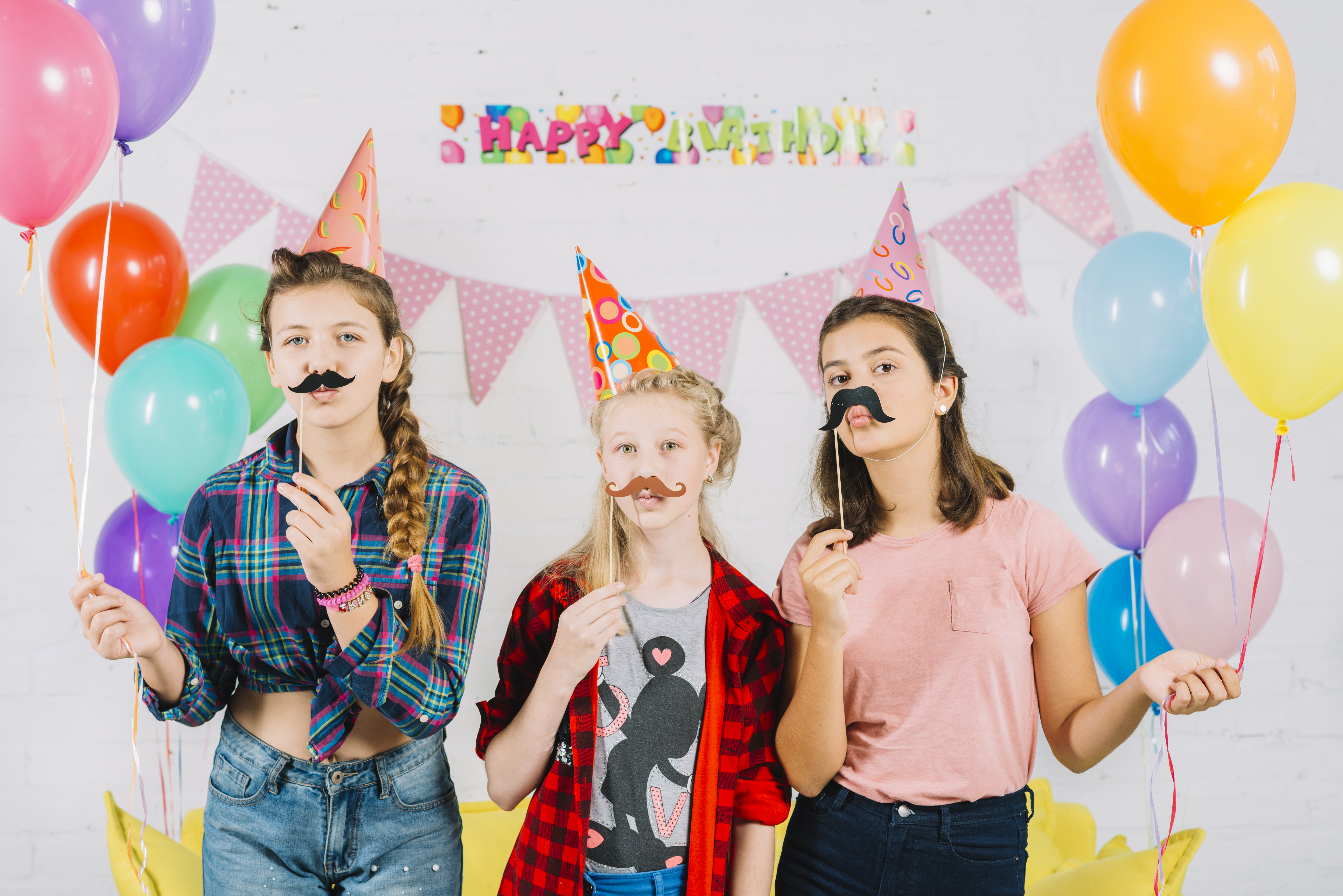 Group friends posing with prop-moustache during birthday